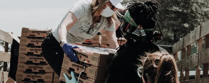 Image of volunteers carrying produce