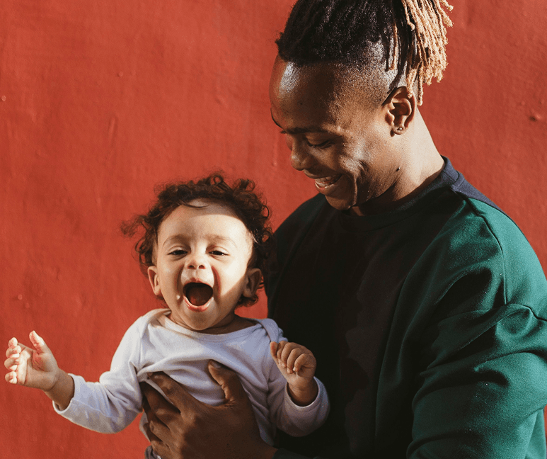 Father holding a laughing baby