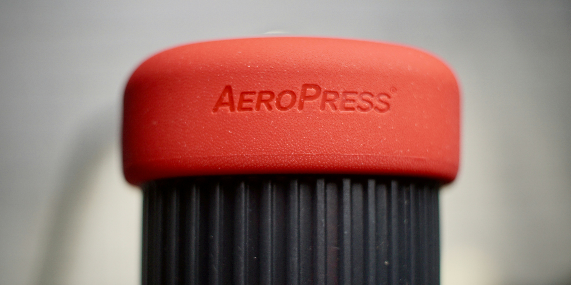 a close up of a red aeropress cup