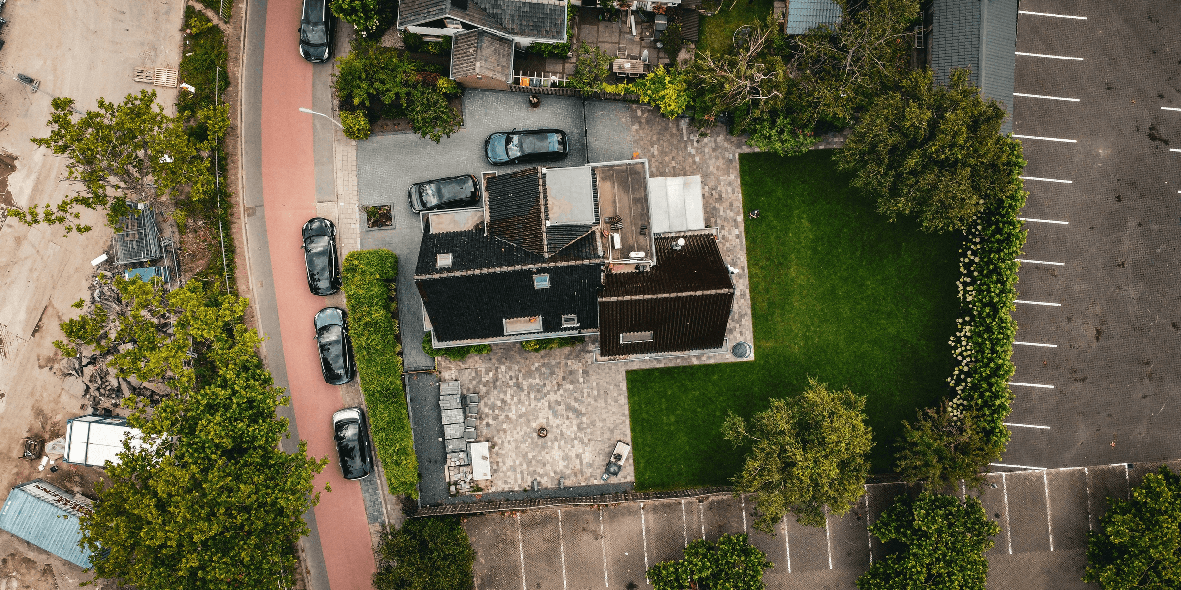 a building with a lawn and cars