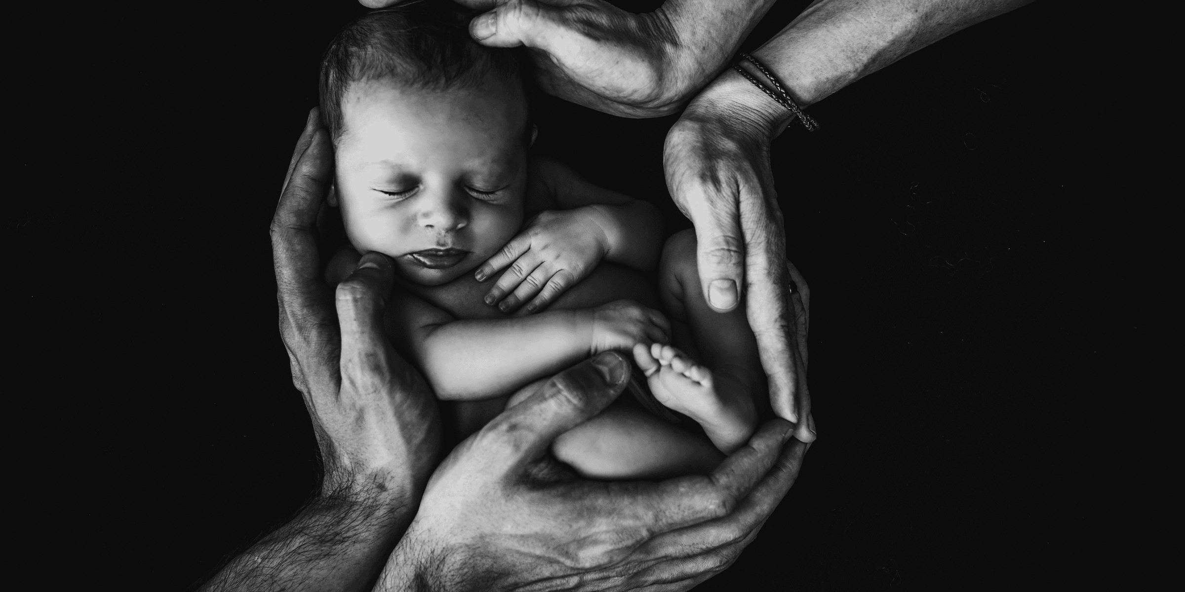 grayscale photo of woman hugging baby
