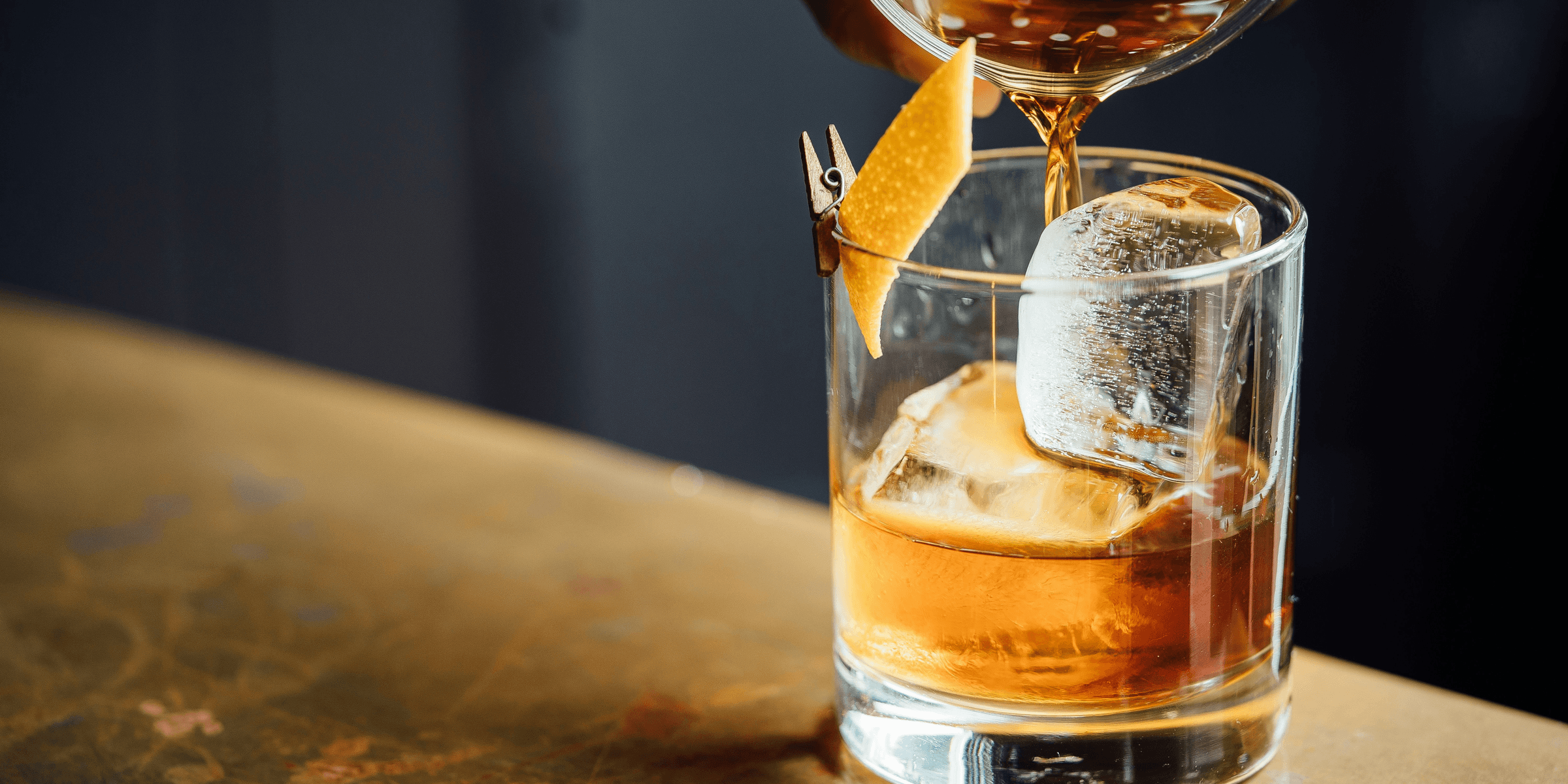 liquor pouring on clear shot glass
