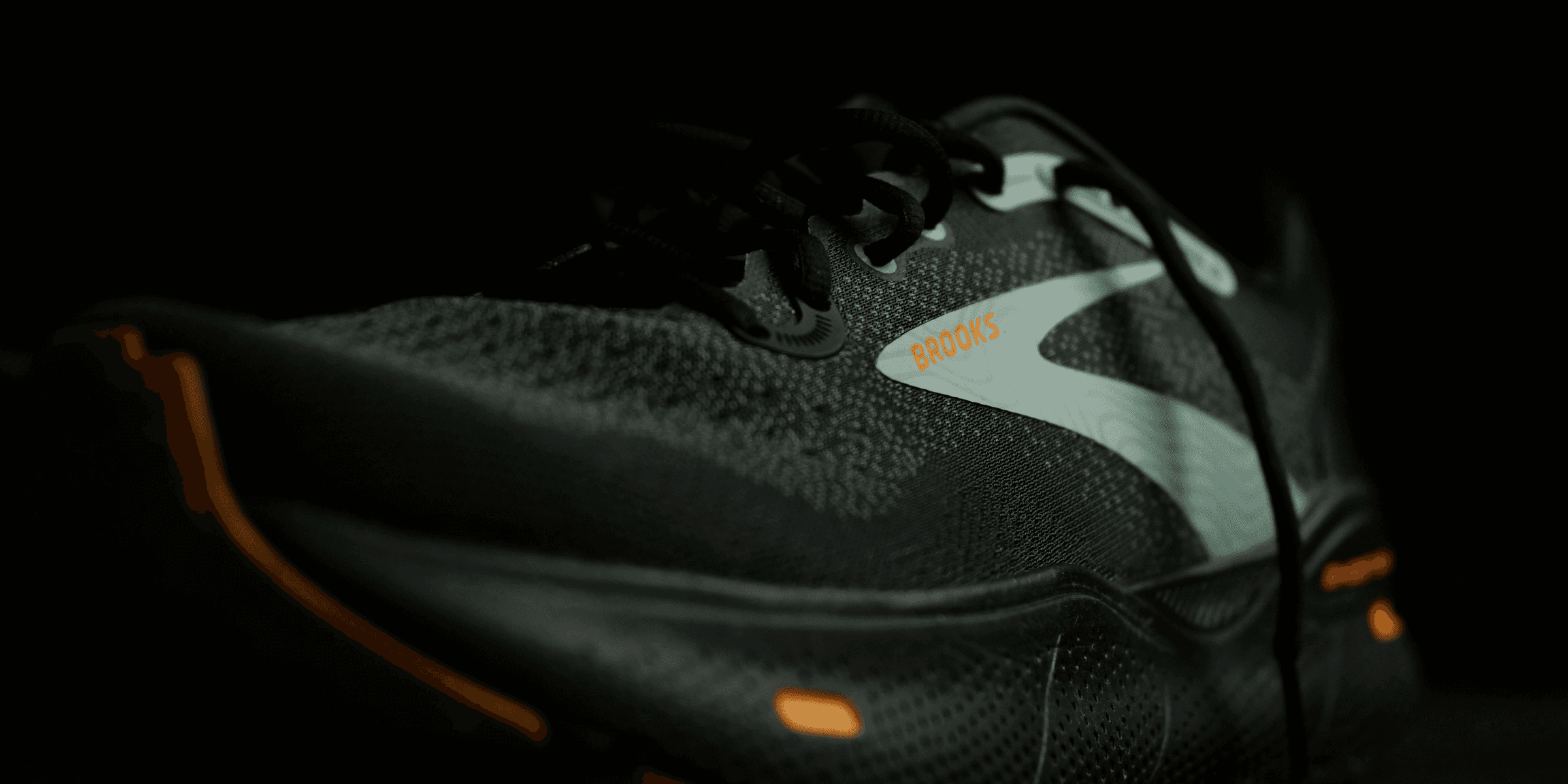 a pair of black and orange running shoes