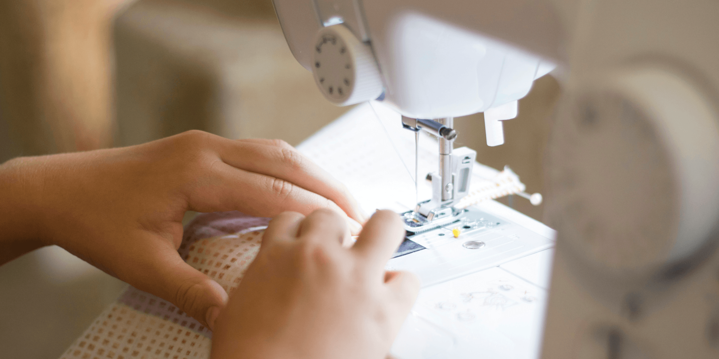 a close up of a person using a sewing machine