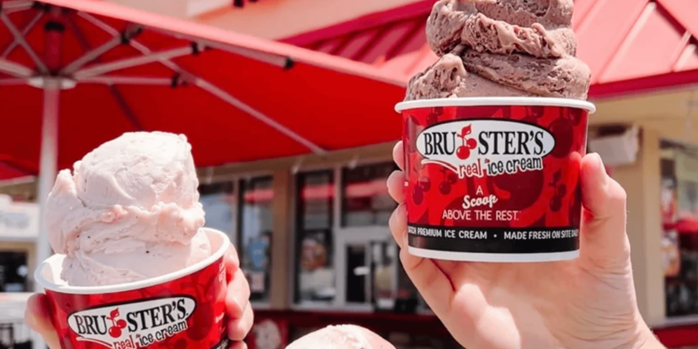 two hands holding one cup of ice cream each, red color palette