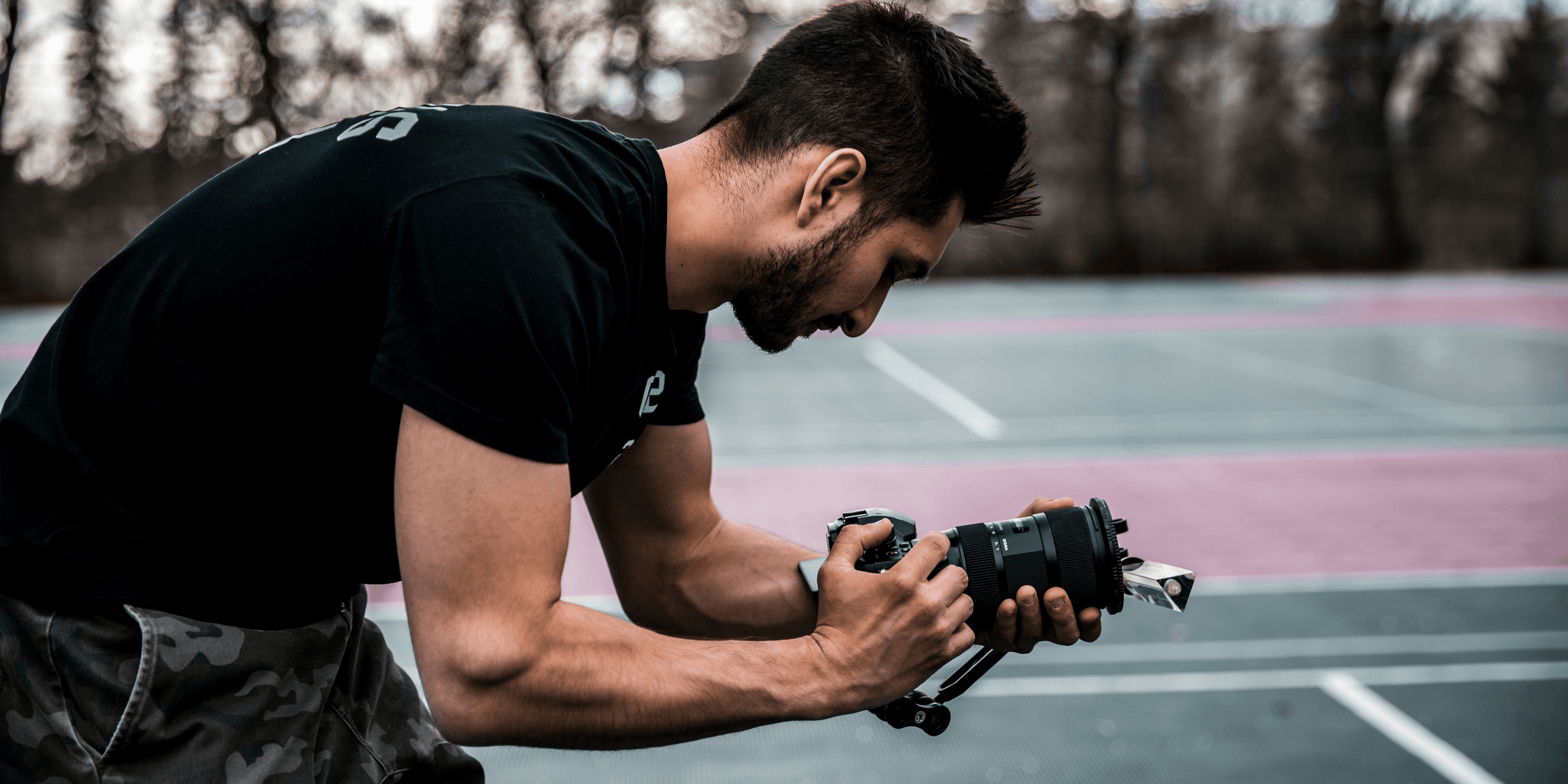 man in black crew neck t-shirt holding black dslr camera