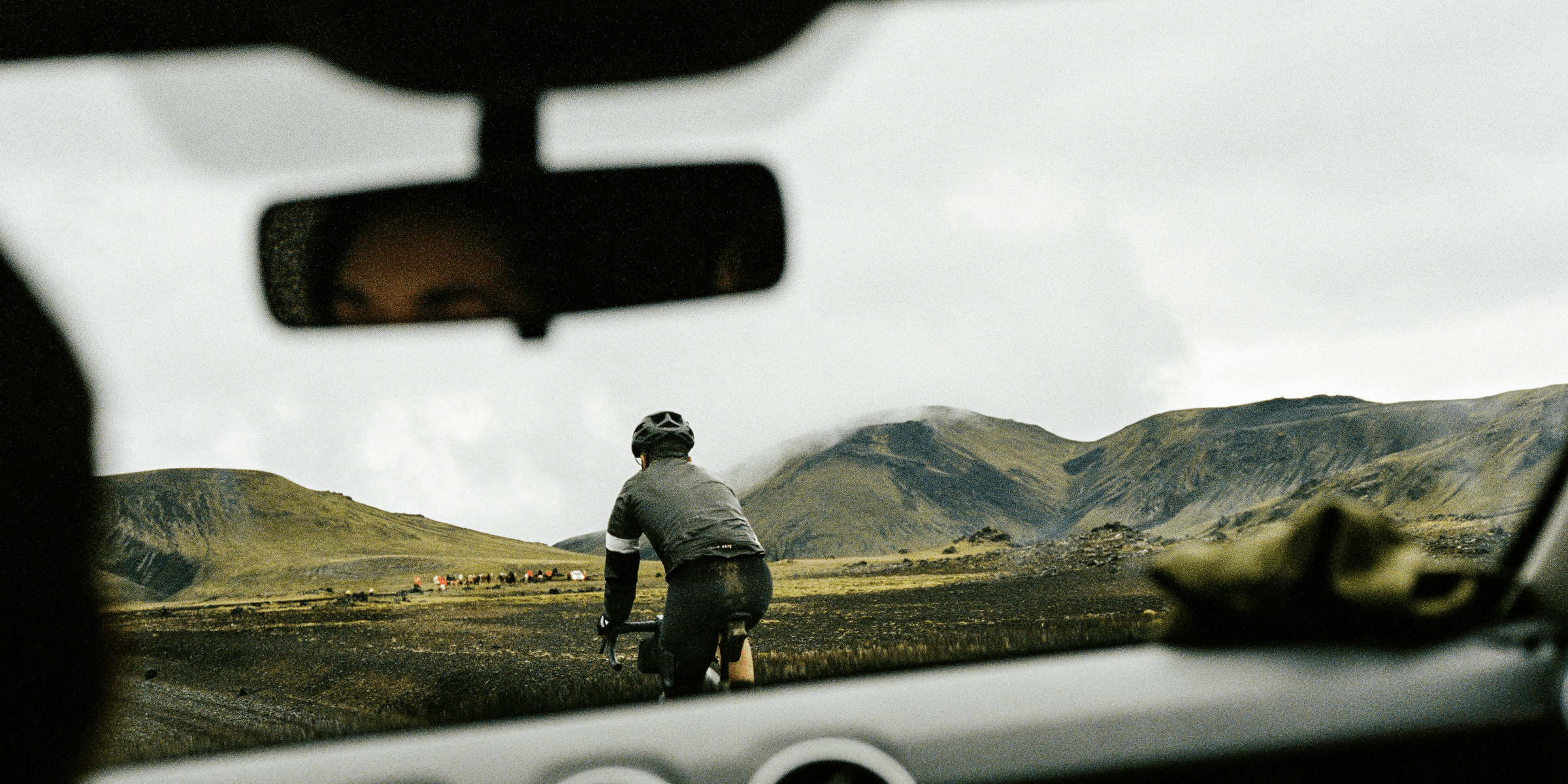 a man riding a bike down a dirt road