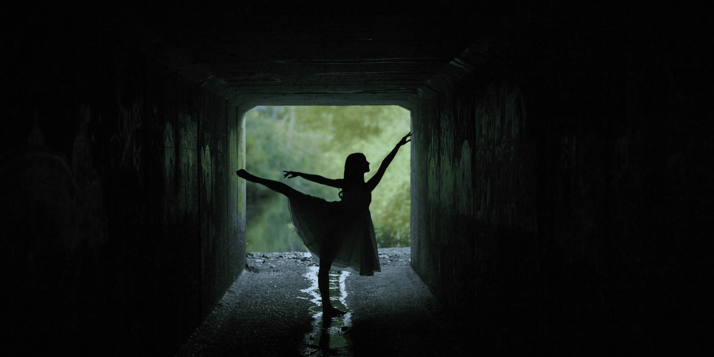 silhouette of woman doing ballet low light photography