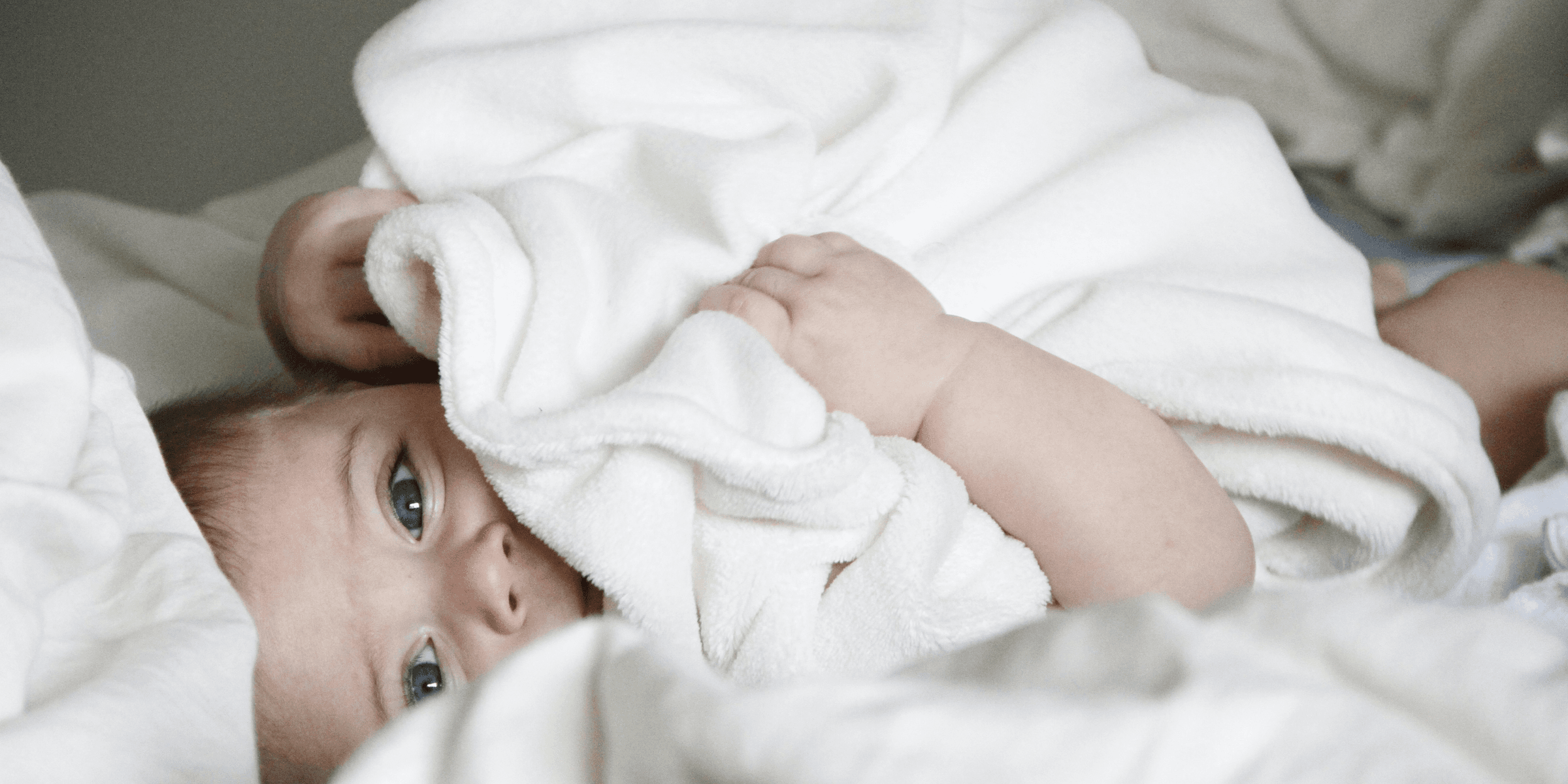 baby laying on bed