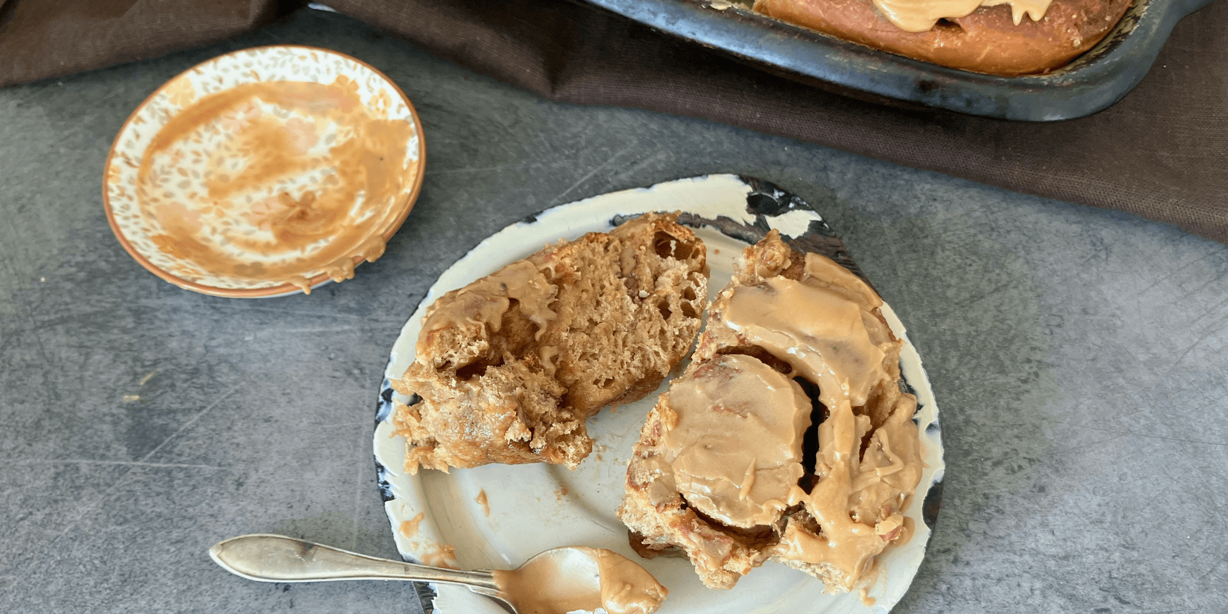 A plate with a piece of cake on it next to a container of peanut butter