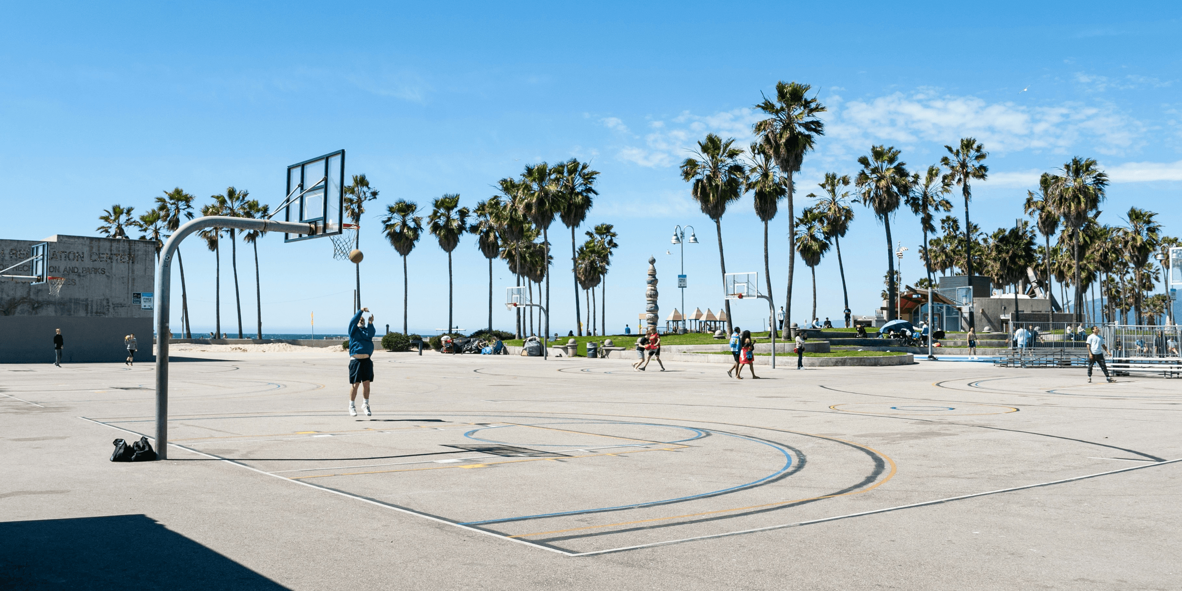 people playing basketball on basketball court during daytime