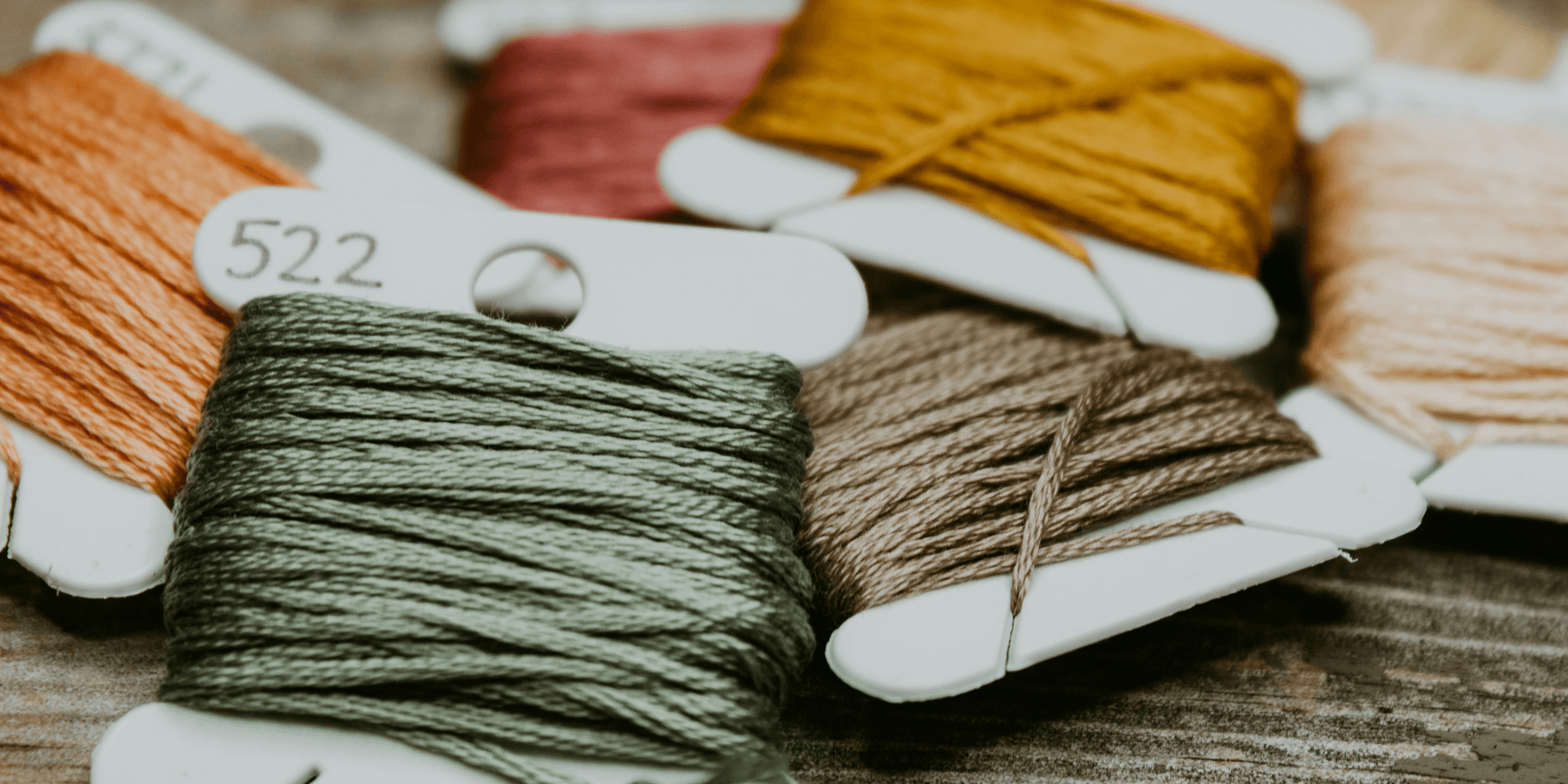 green and yellow yarn on brown wooden table