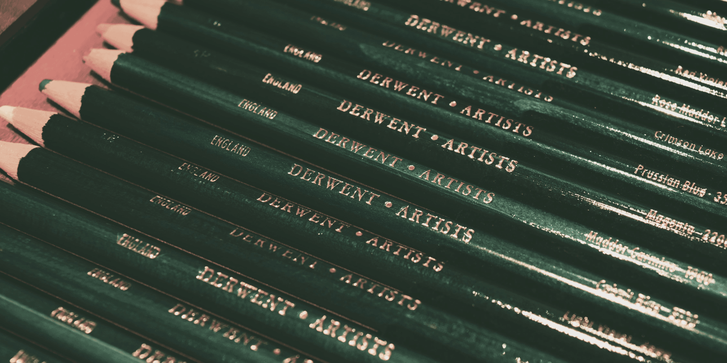 A row of green pencils sitting on top of each other.