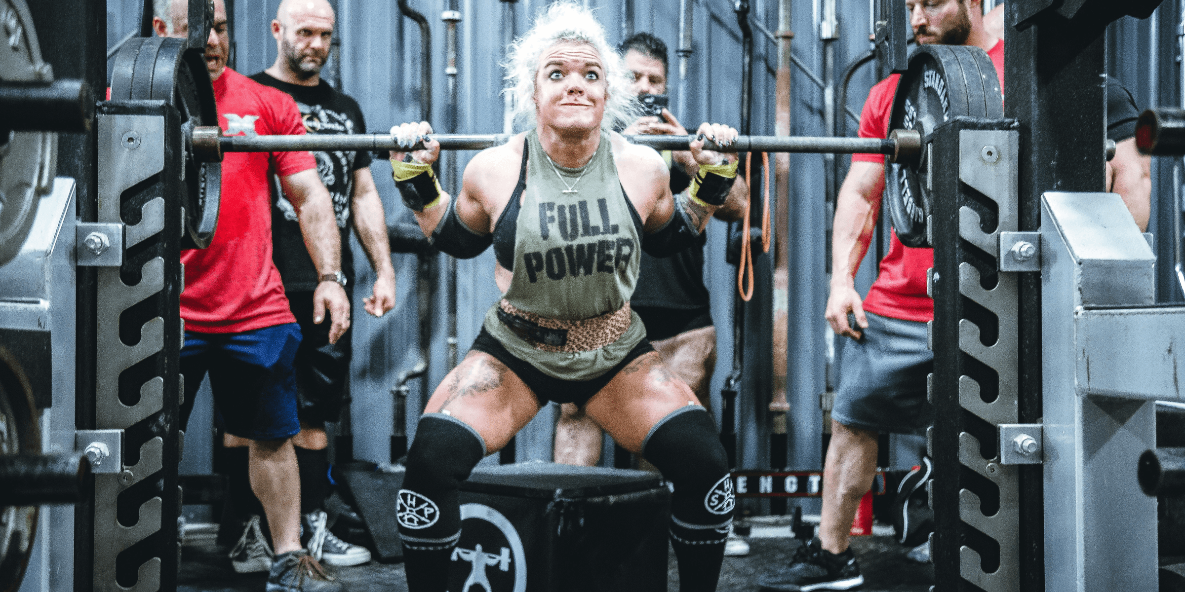 woman lifting barbell.