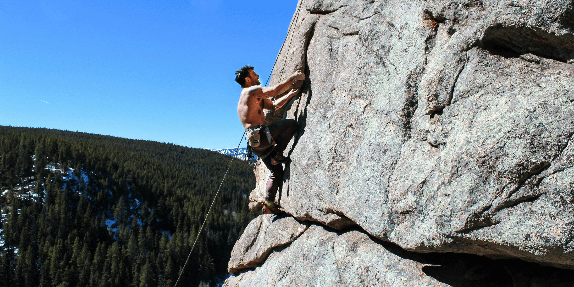 man rockclimbing at daytime.