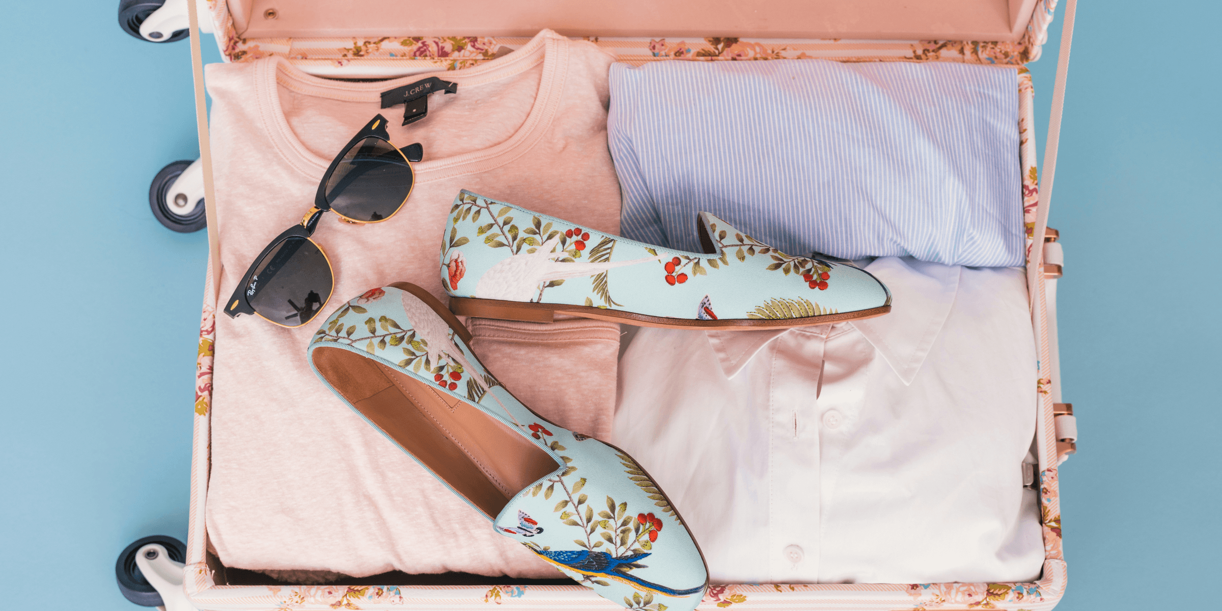 clothing items and pair of shoes in luggage.