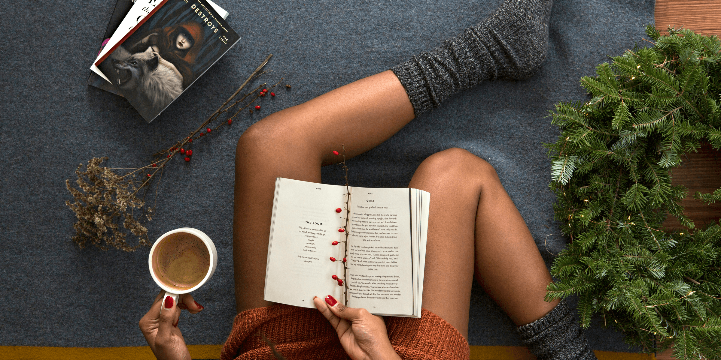 opened book on person's lap with gray socks.