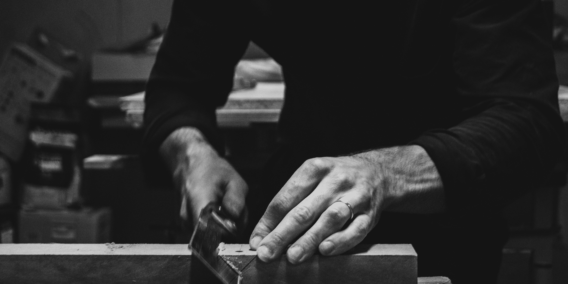 a man using a table saw to cut a piece of wood.