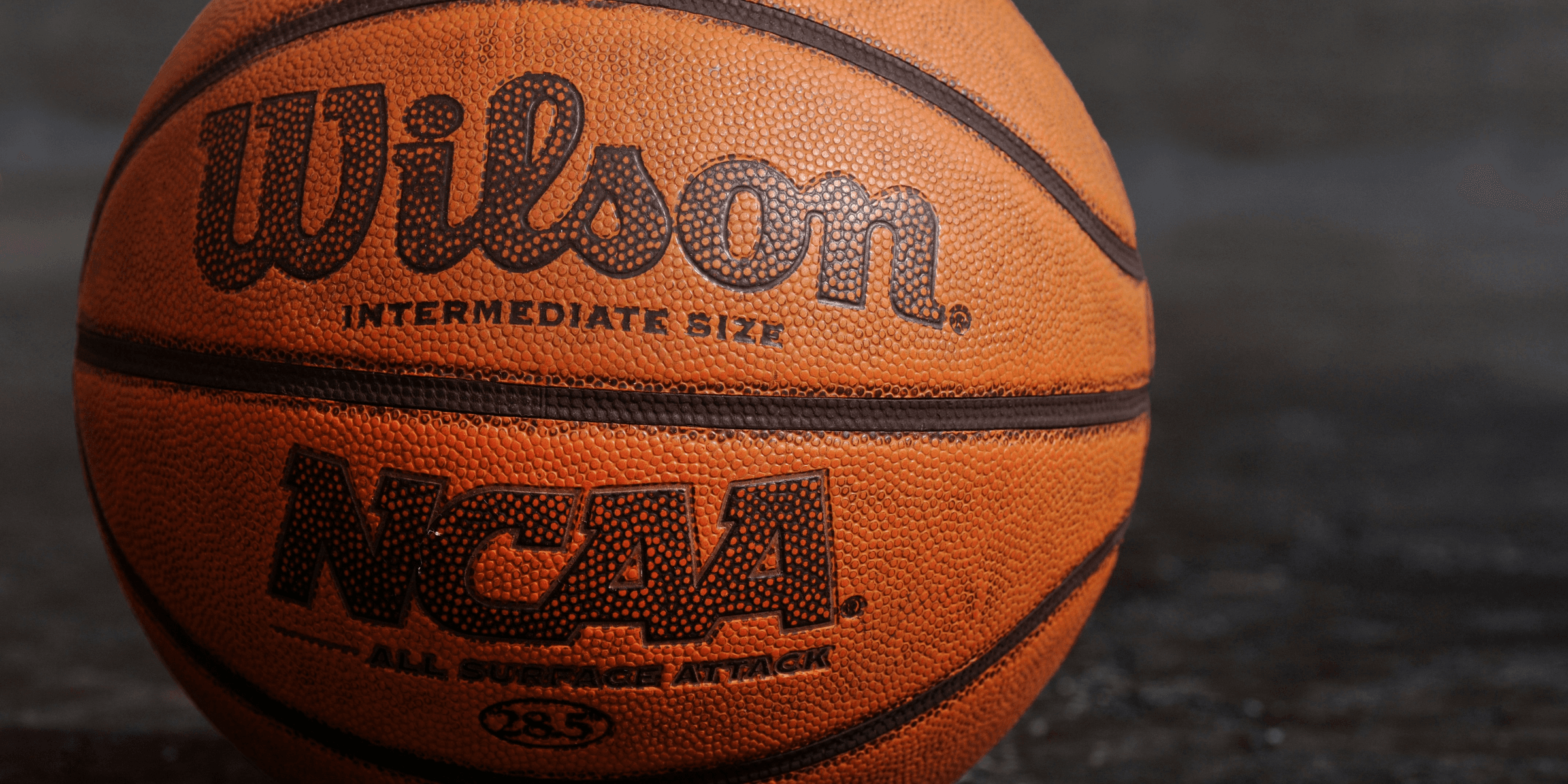 Wilson NCAA basketball on black board