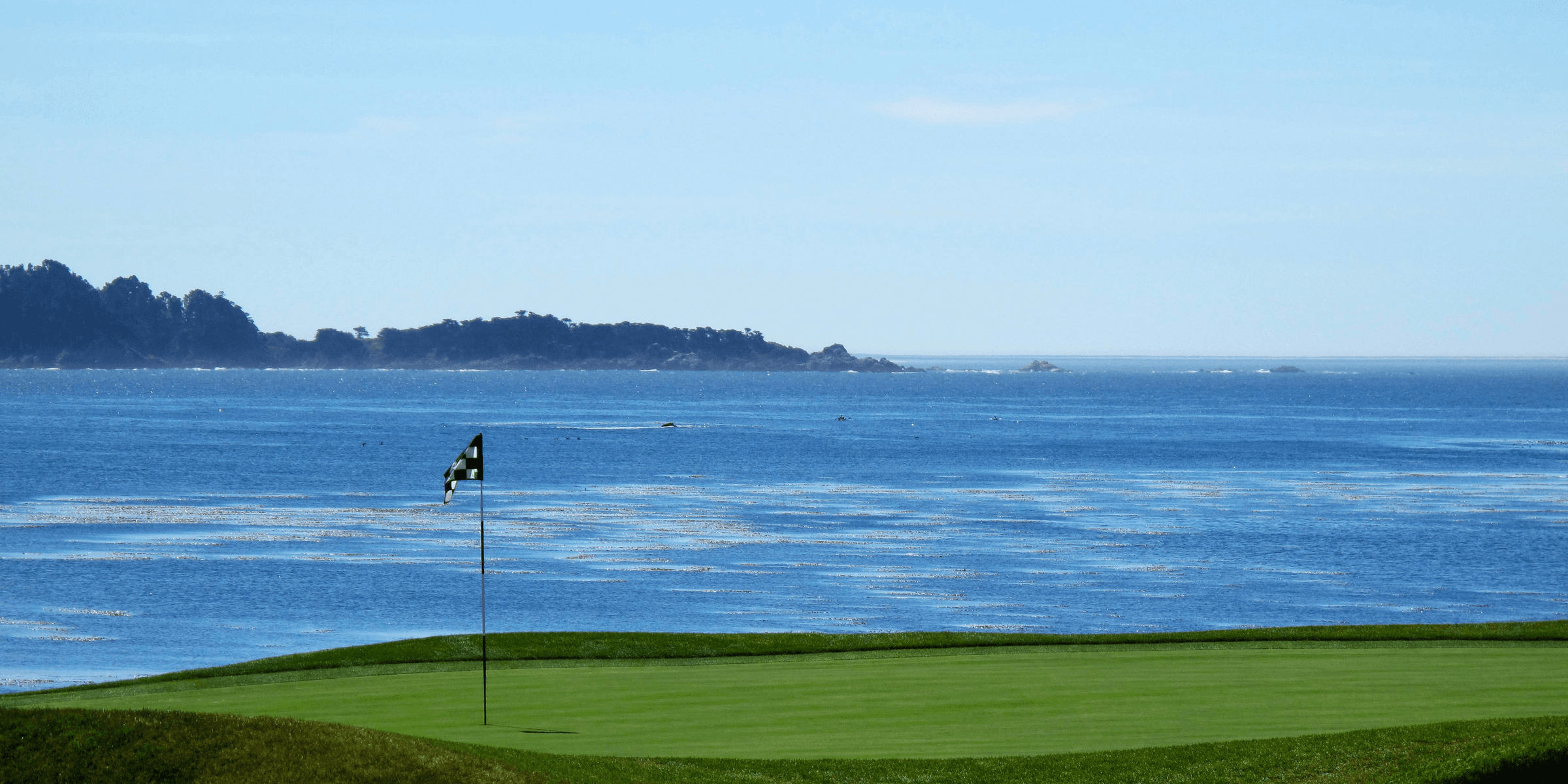golf course near body of water.