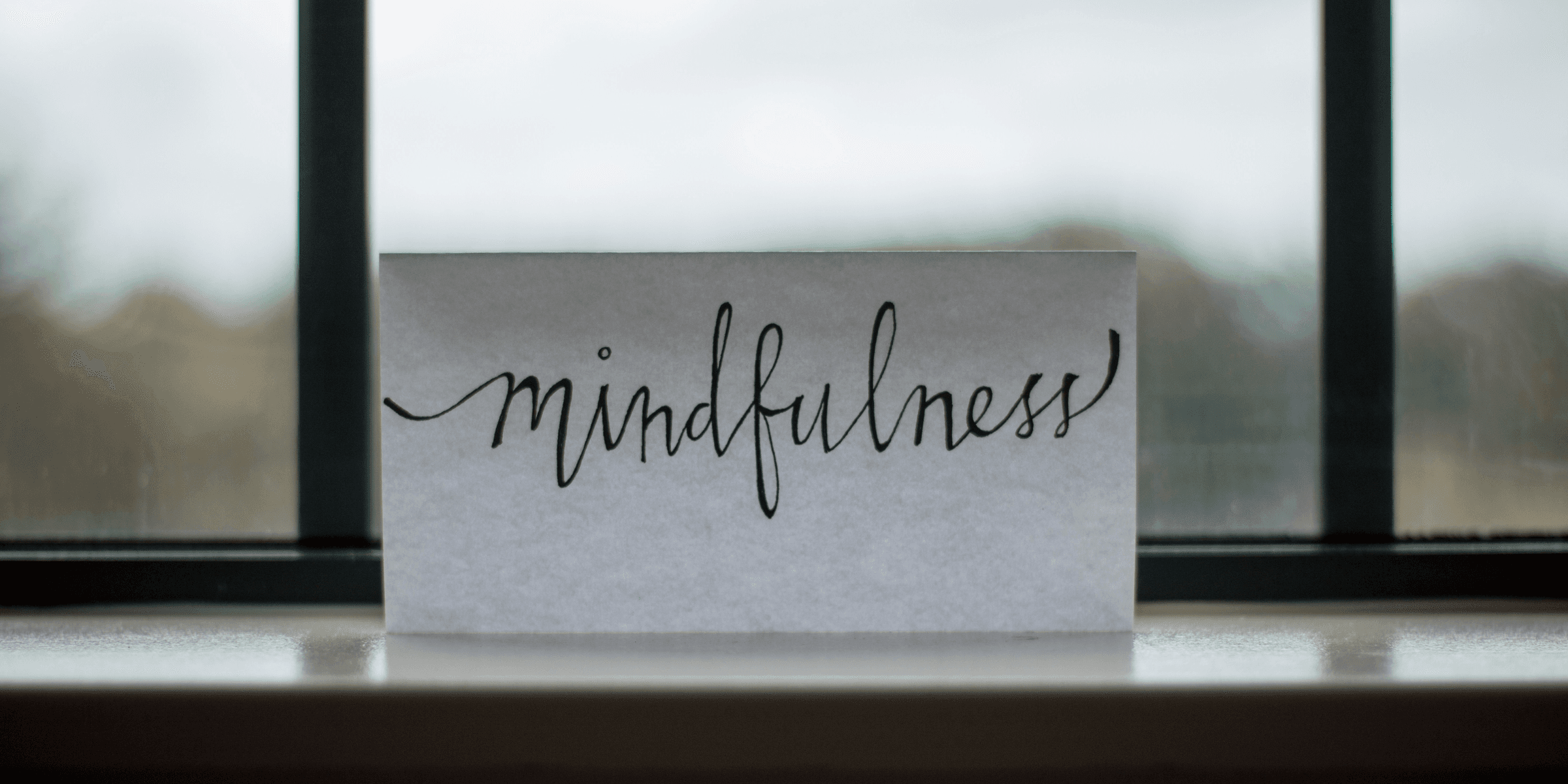 mindfulness printed paper near window.