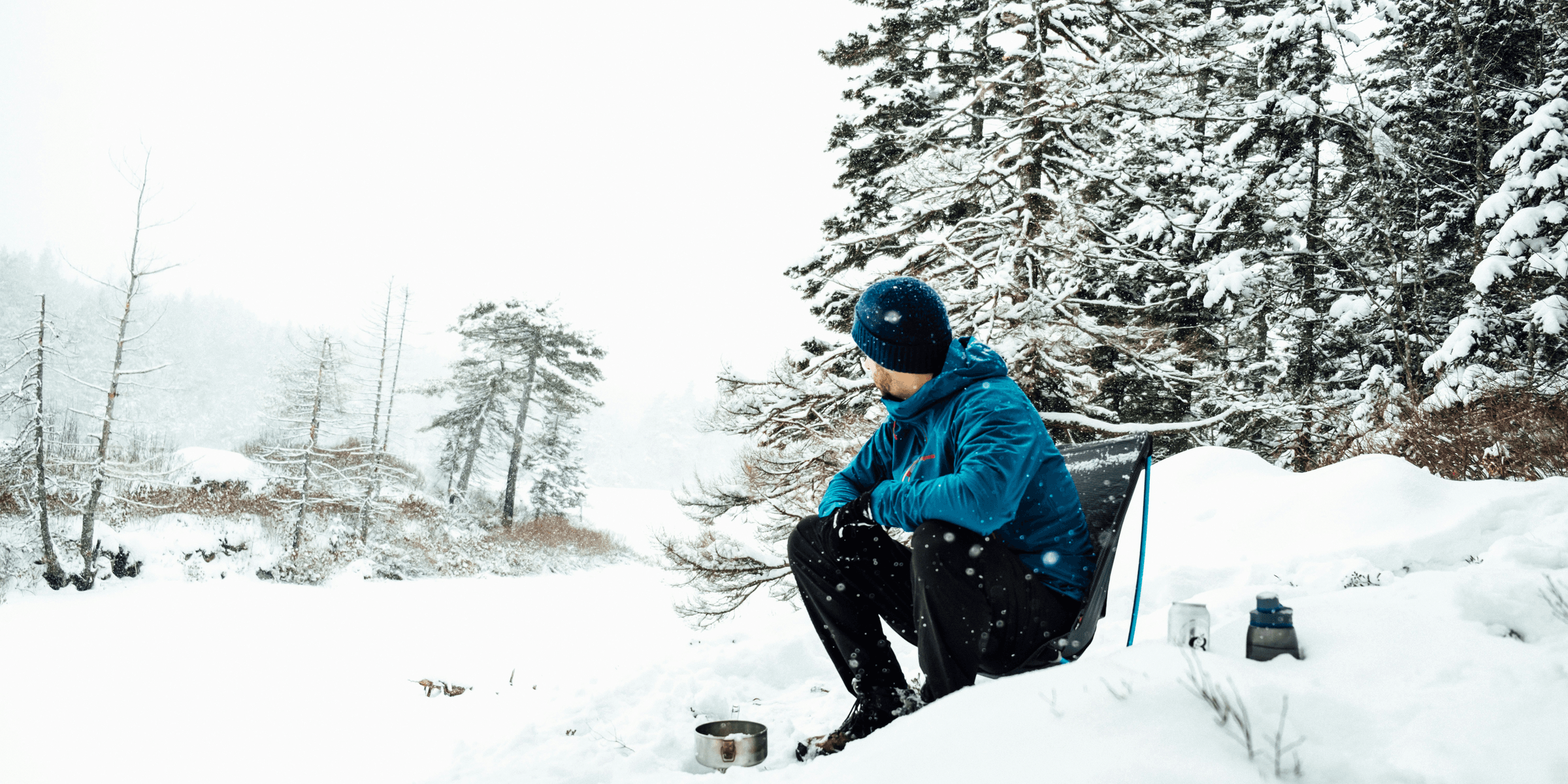 man in blue coat sitting on chair.
