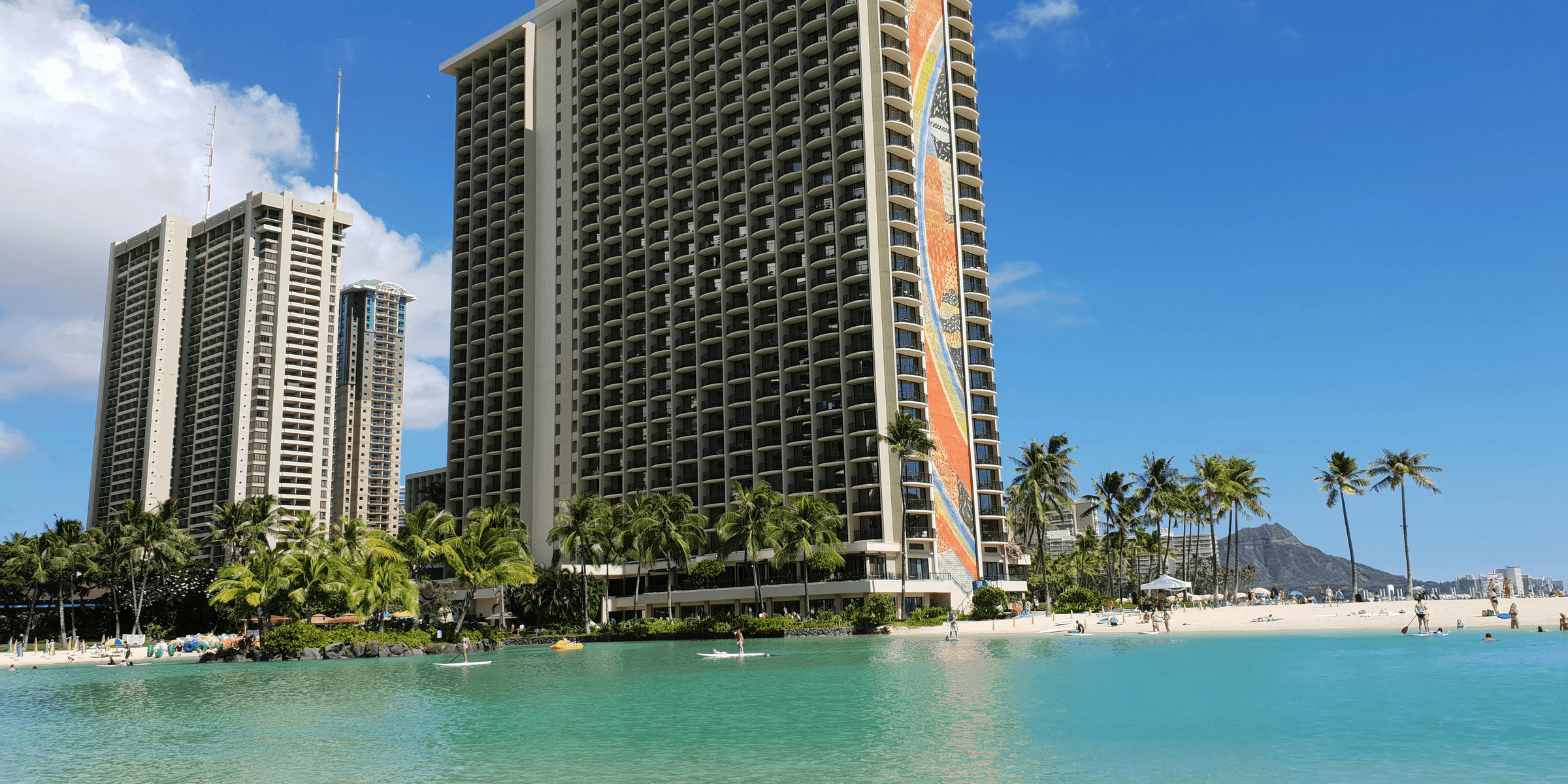 white and brown high rise building near body of water during daytime.