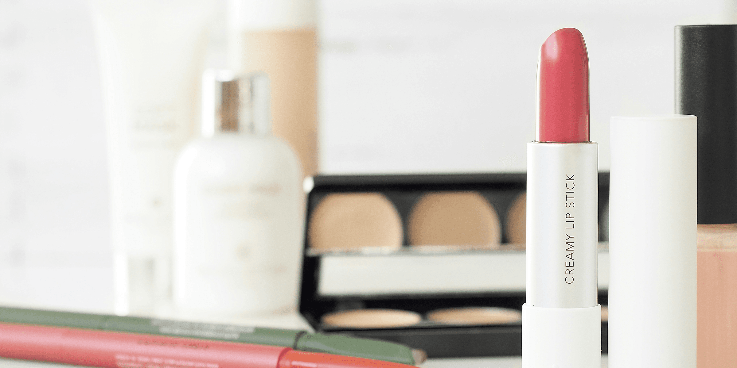 assorted-brand makeup lot on desk.