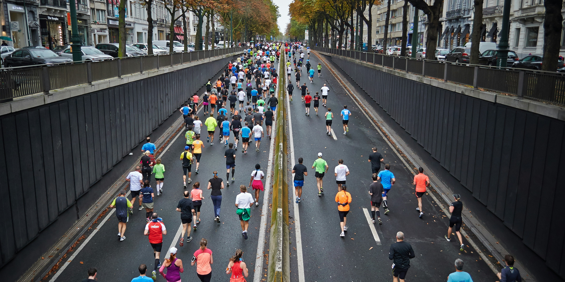 people running on road during daytime.