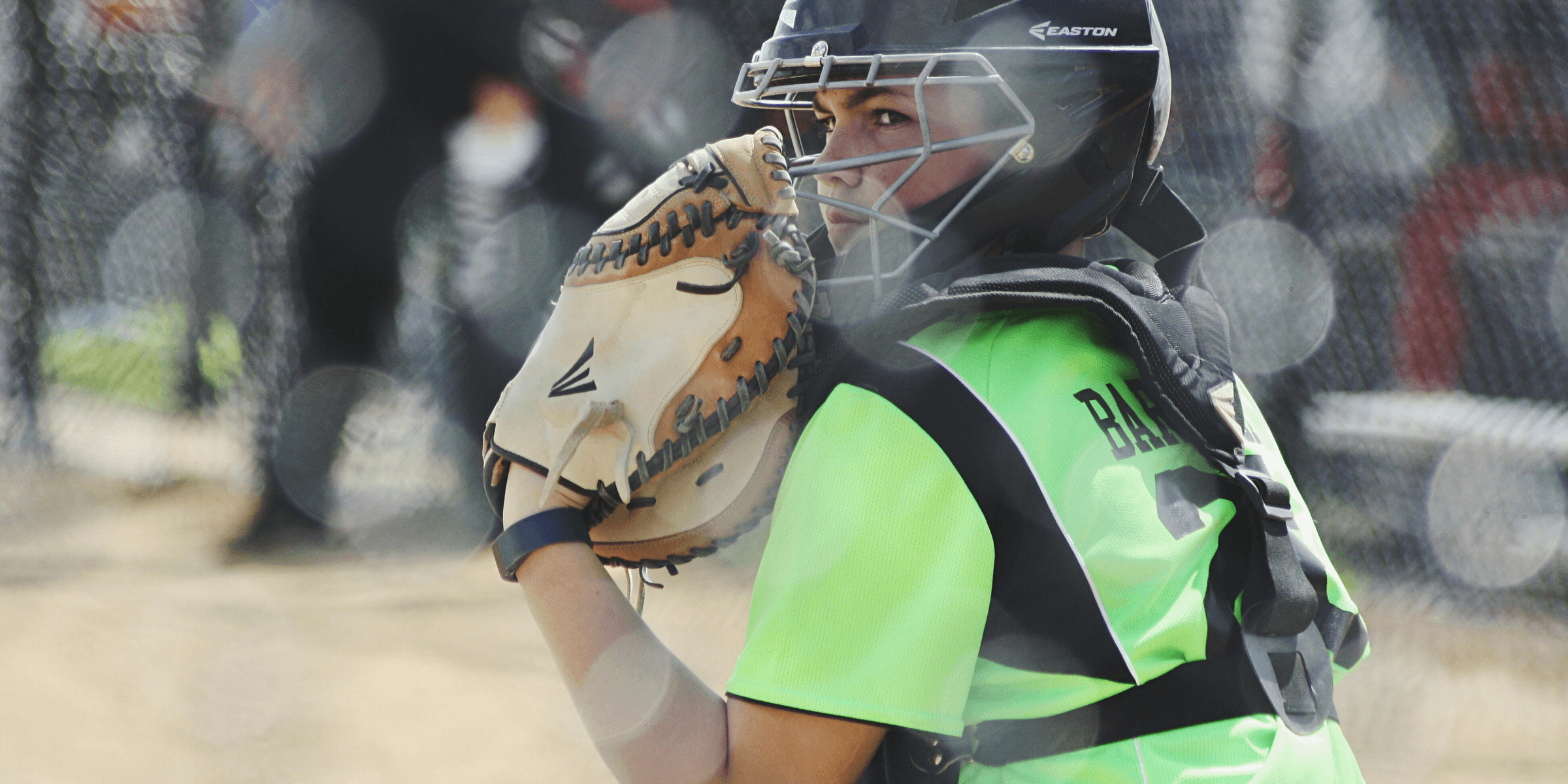 woman wearing brown Easton baseball mitt playing baseball.