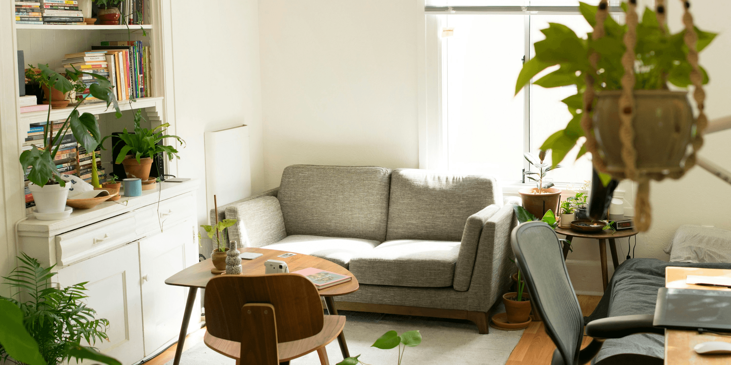 gray fabric loveseat near brown wooden table.