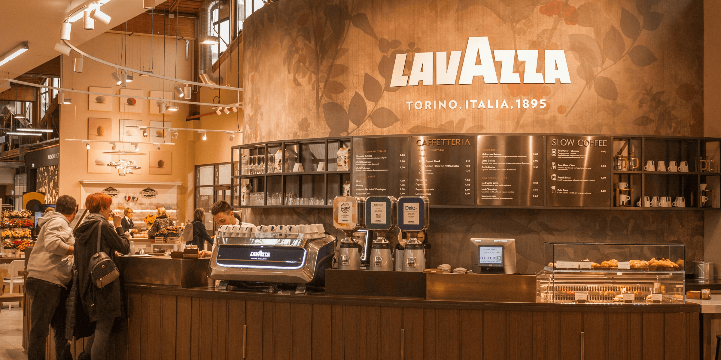 black and silver coffee machine on brown wooden counter.