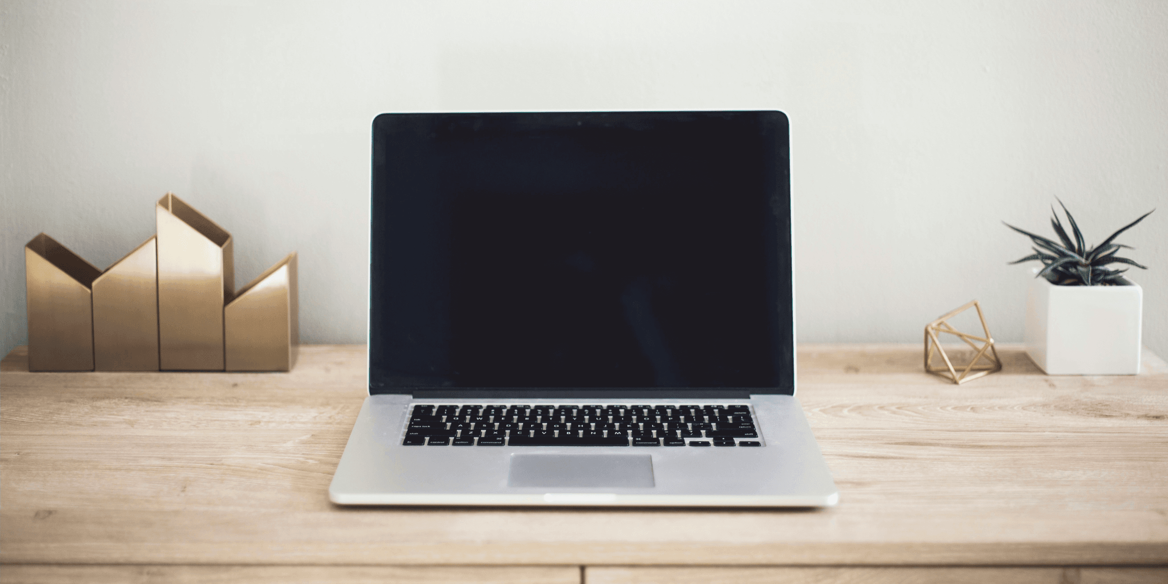 MacBook Pro on top of brown table.