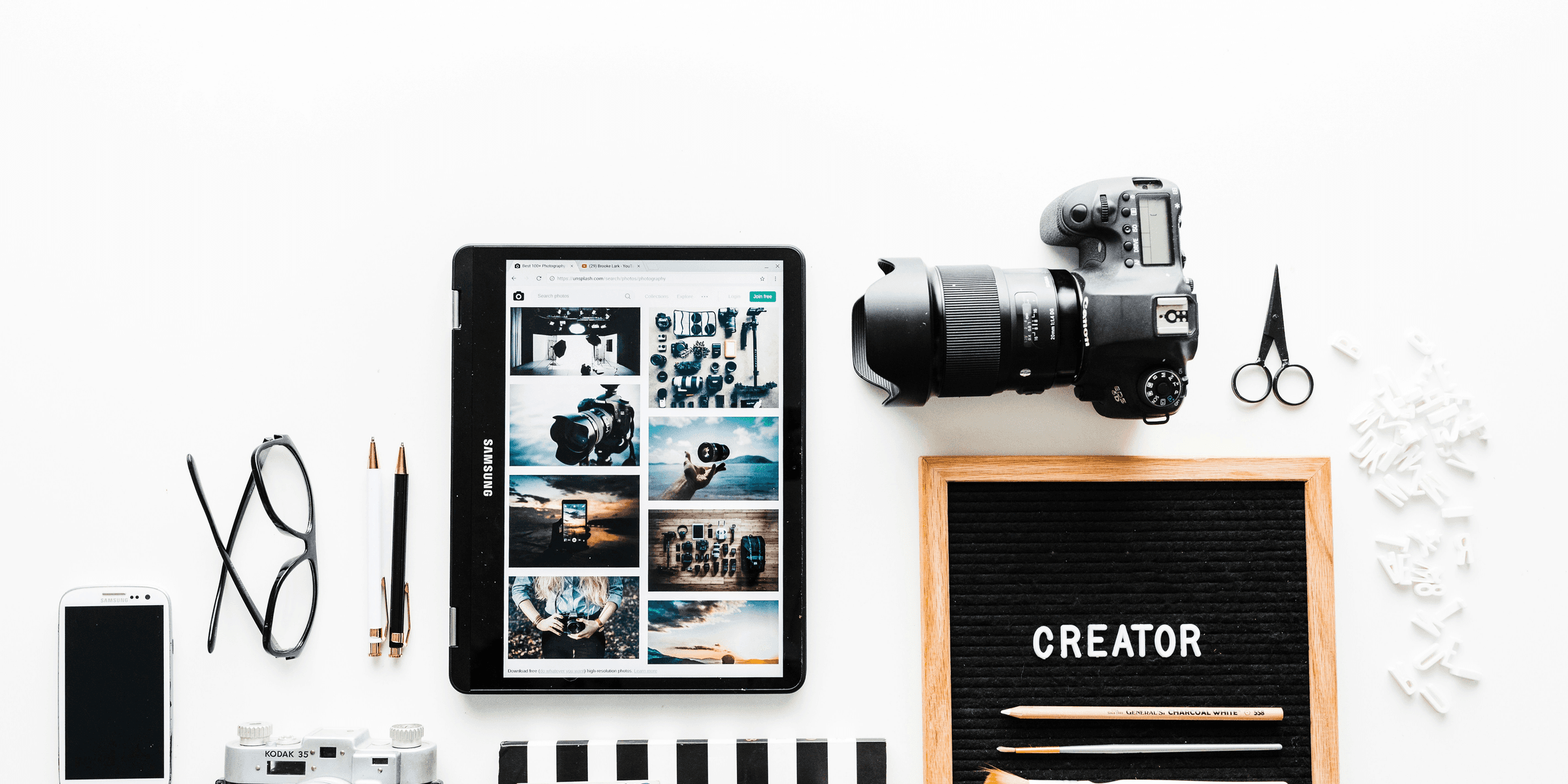 flat view of cameras beside computer tablet and smartphone.