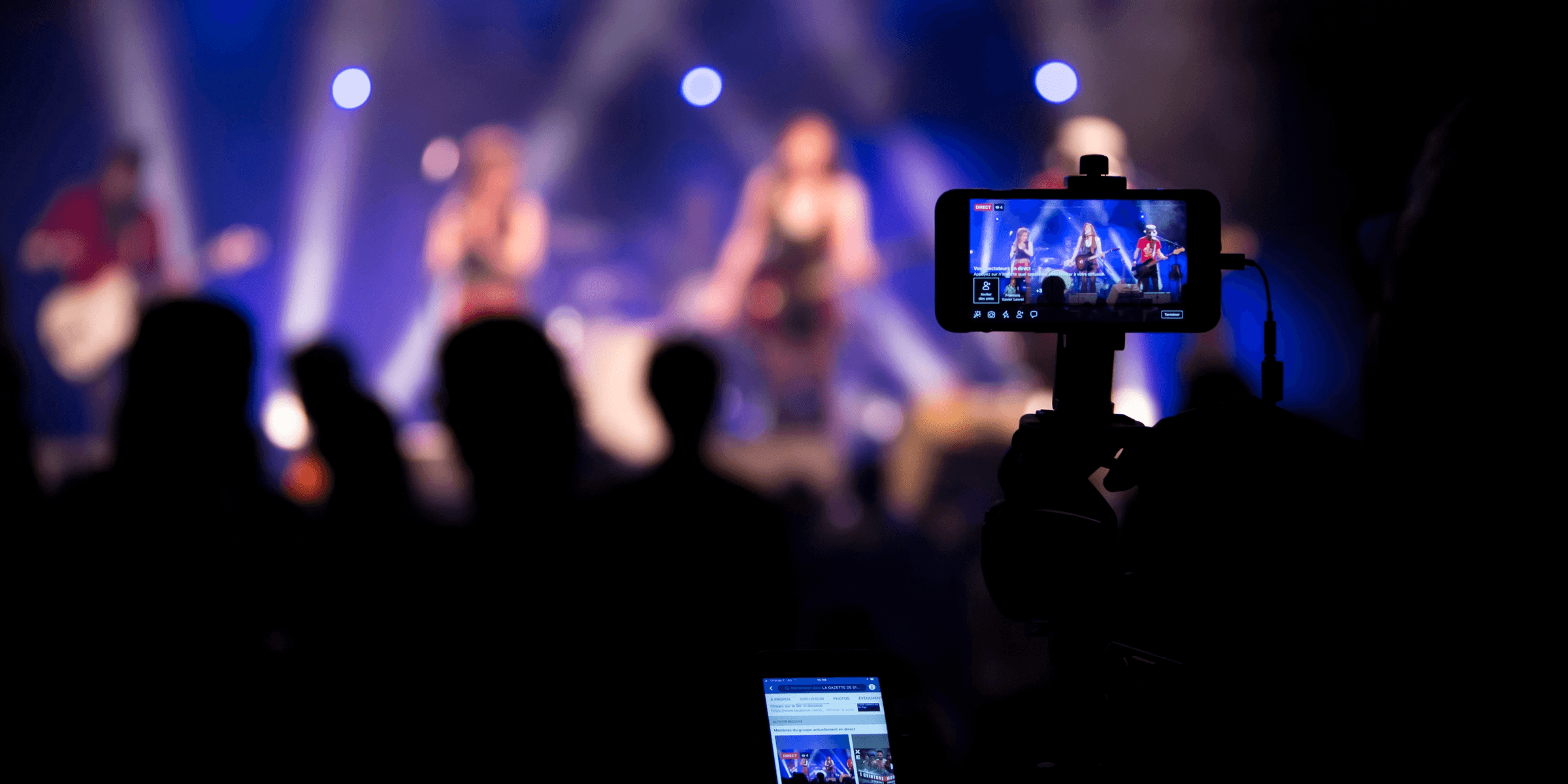 people taking videos during concert.