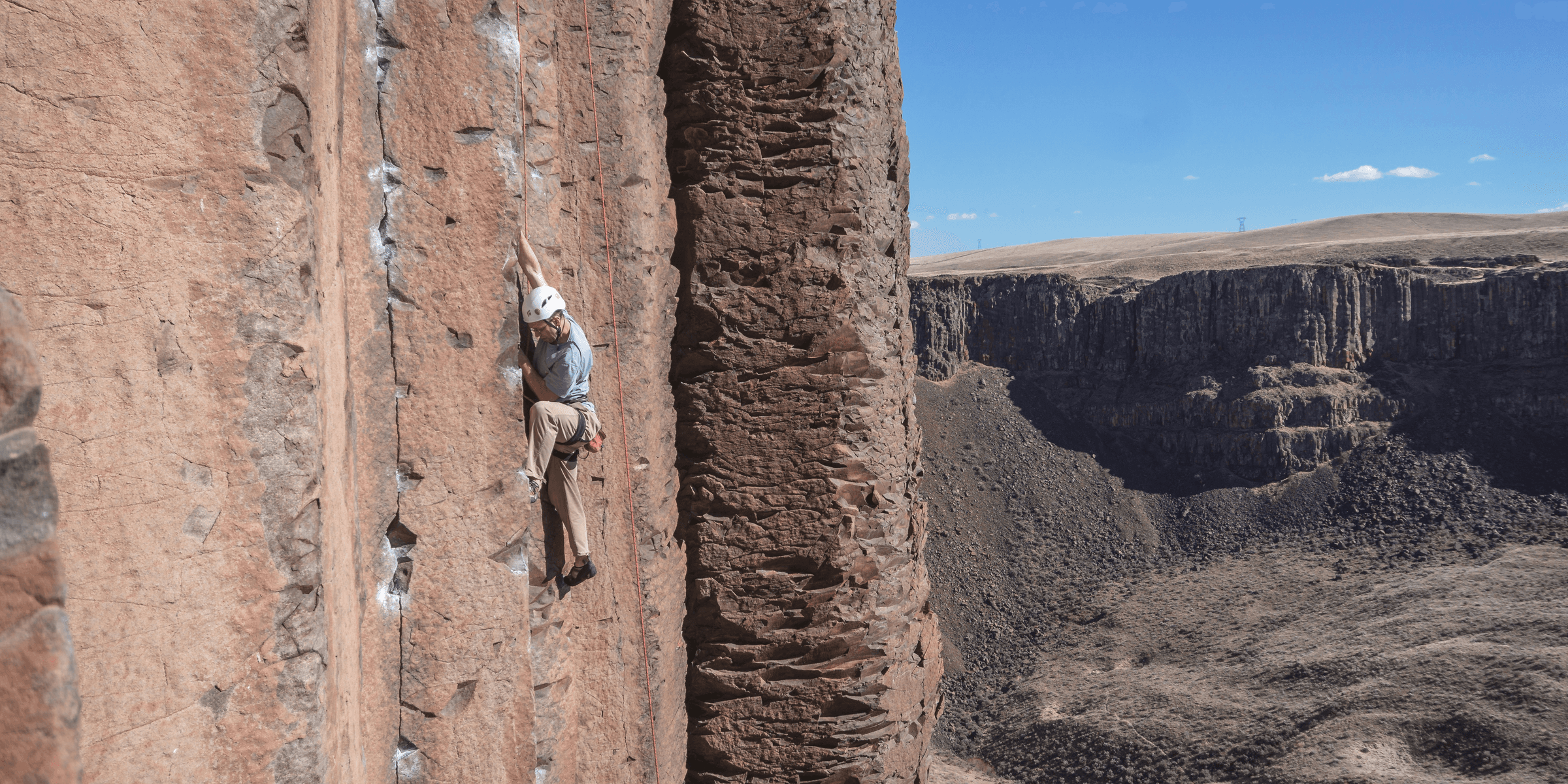man mountain climbing during daytime