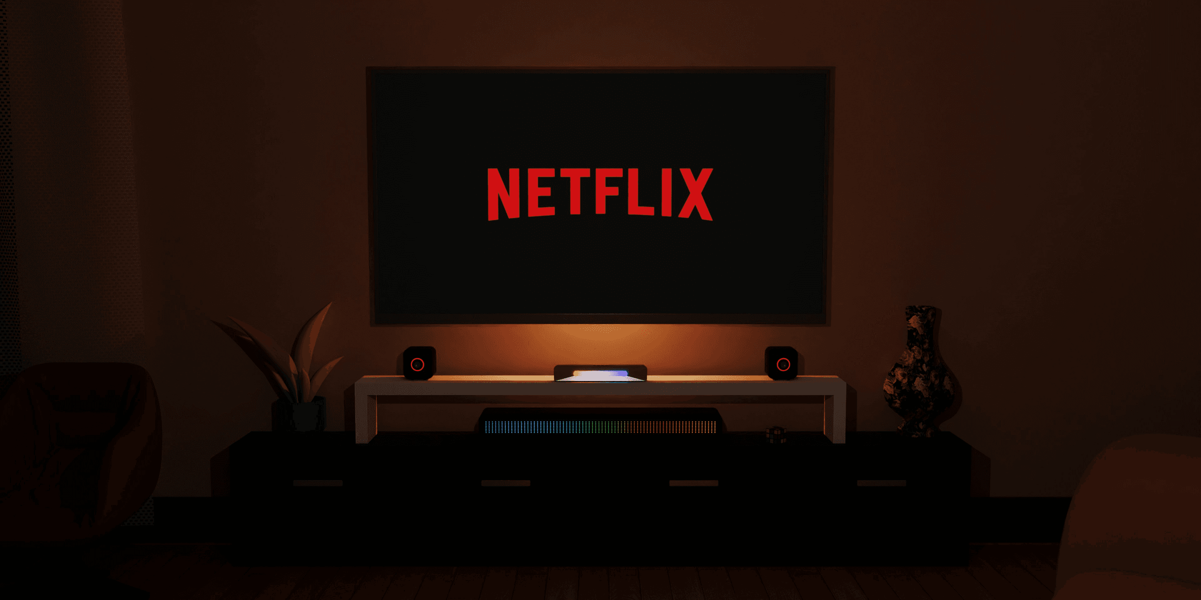 a dark room with a television and a neon netflix sign