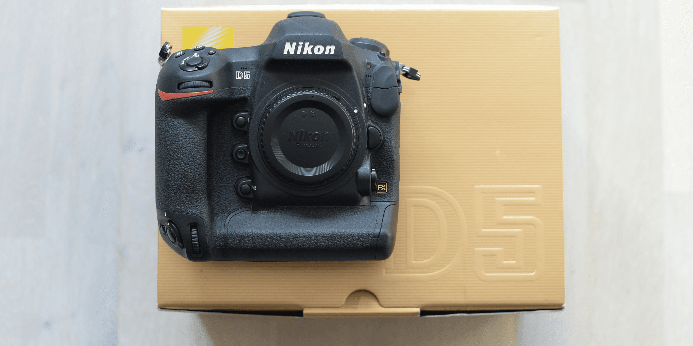 black Nikon DSLR camera with box