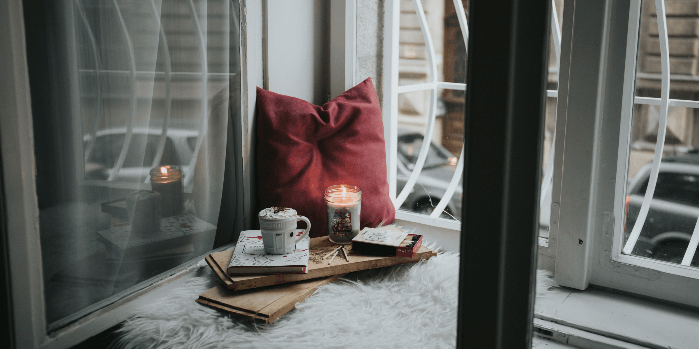 photo of gel candle on board beside pillow.