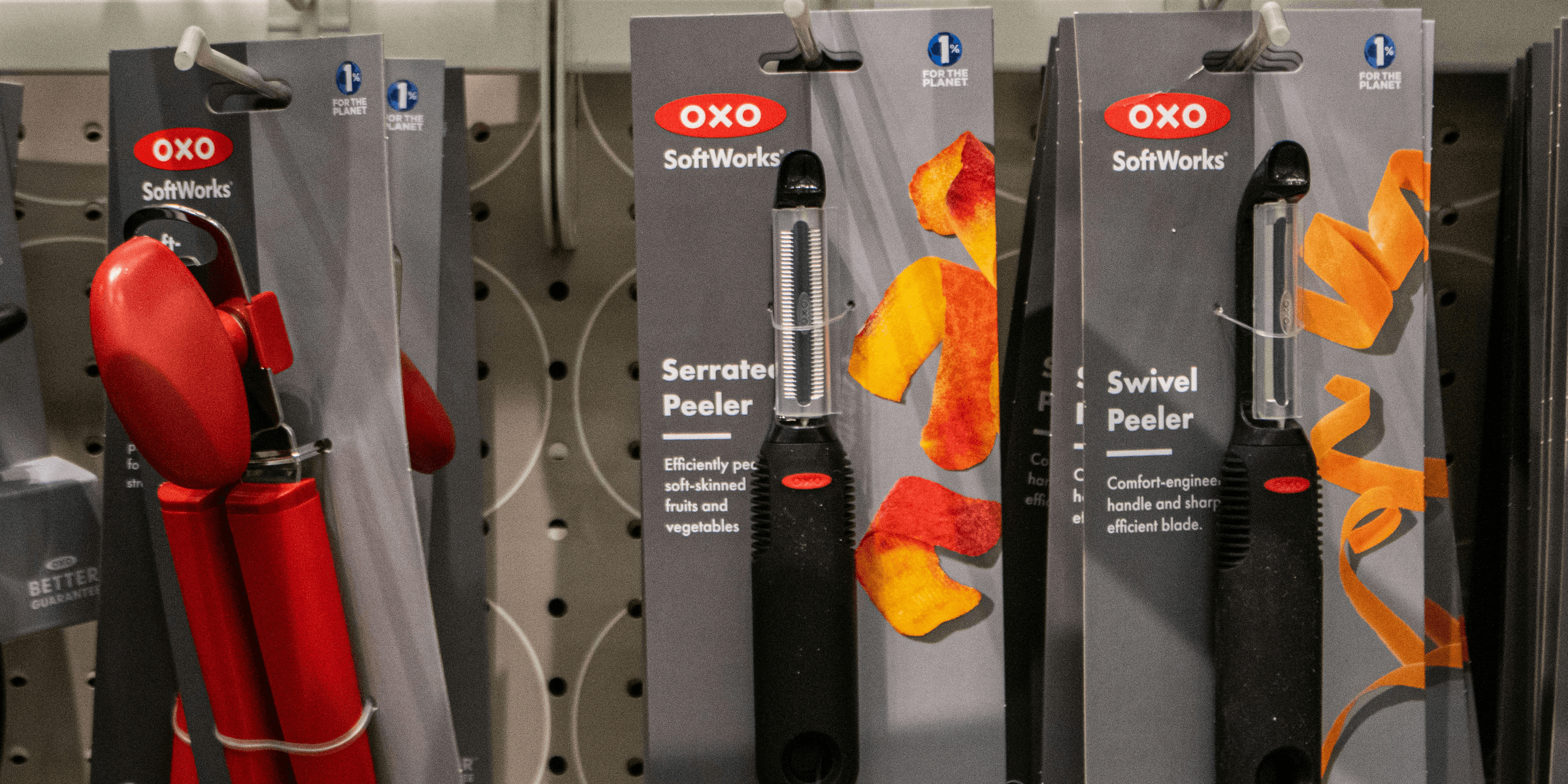Kitchen tools are displayed on a store shelf.