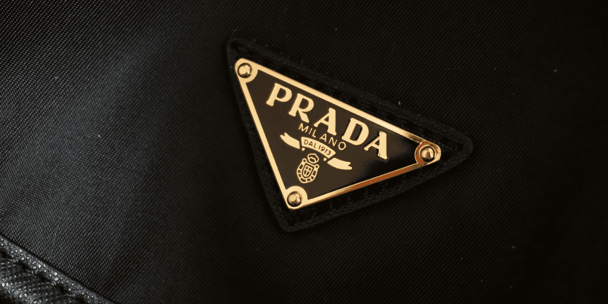 a prada logo on a black jacket.
