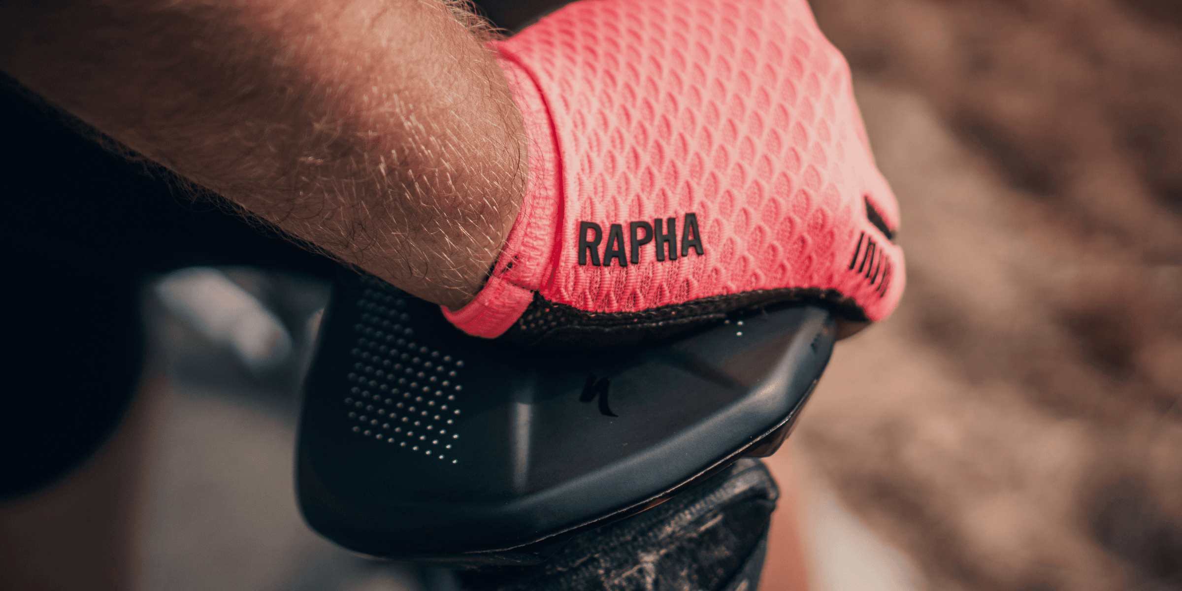 person wearing pink Rapha gloves.