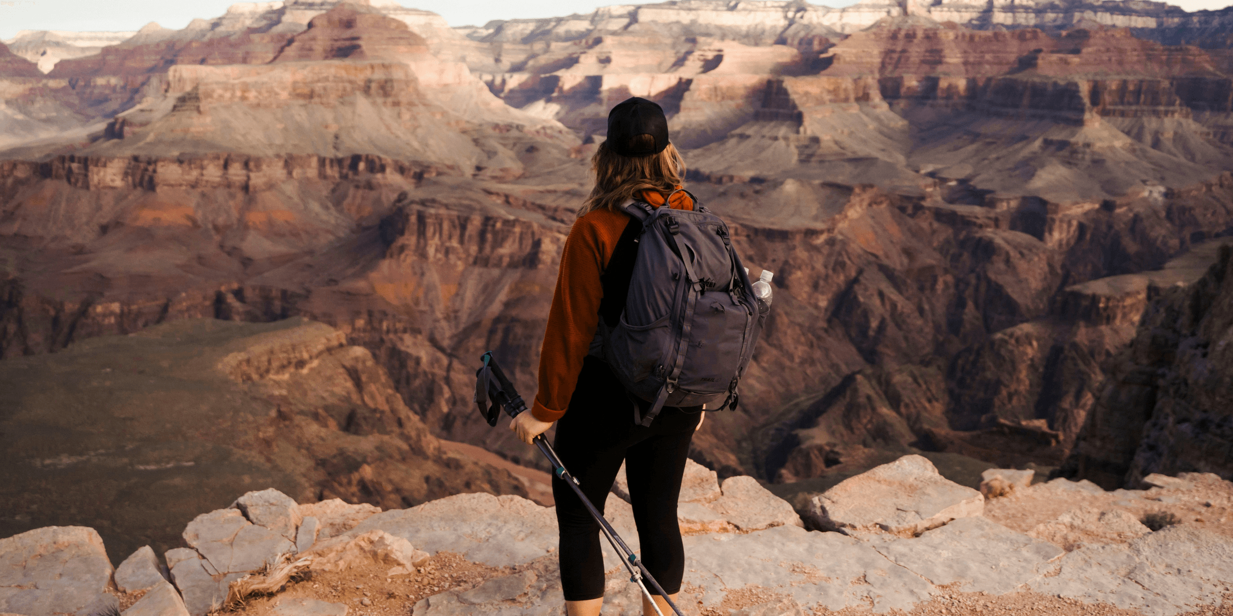man in black jacket and black backpack standing on rocky ground during daytime