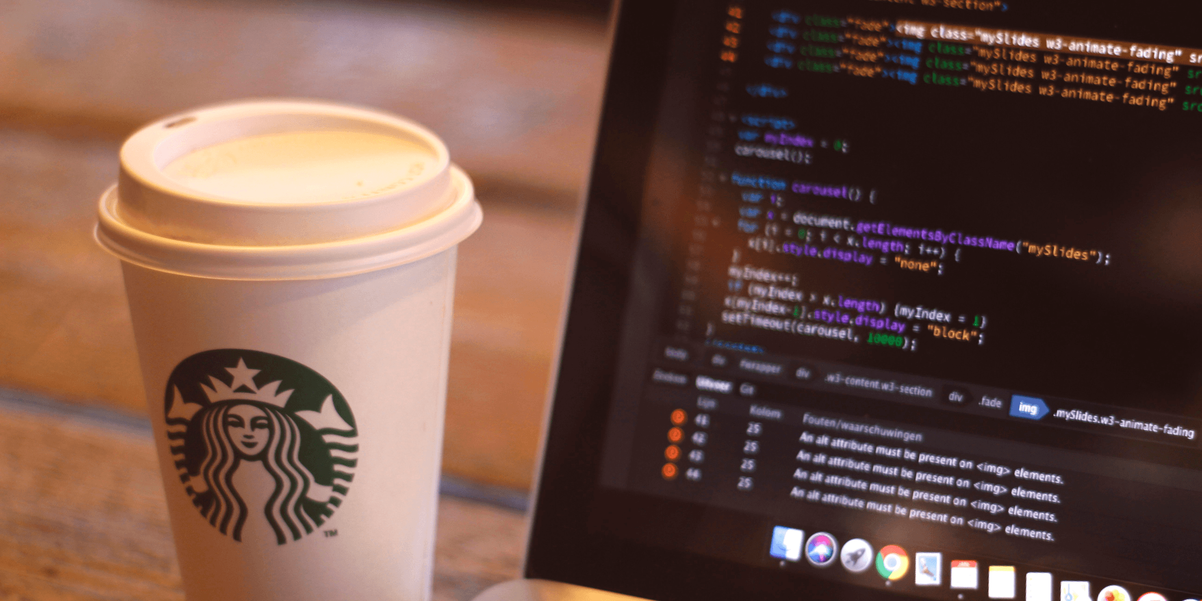 white starbucks cup beside black and silver laptop computer