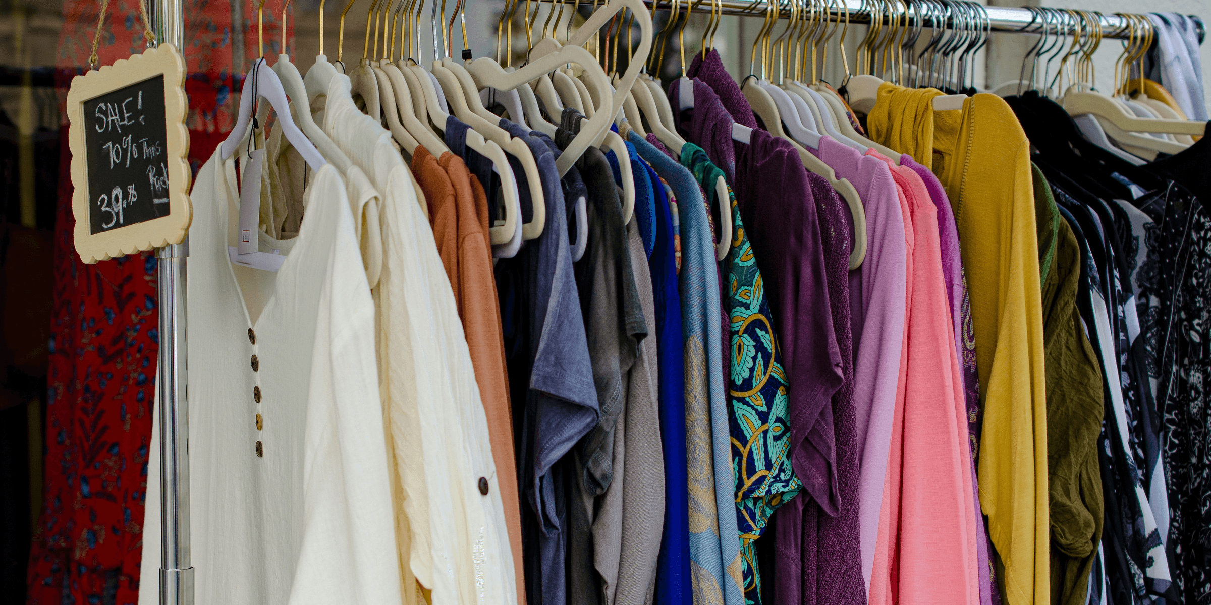 assorted clothes hanged on clothes hanger.