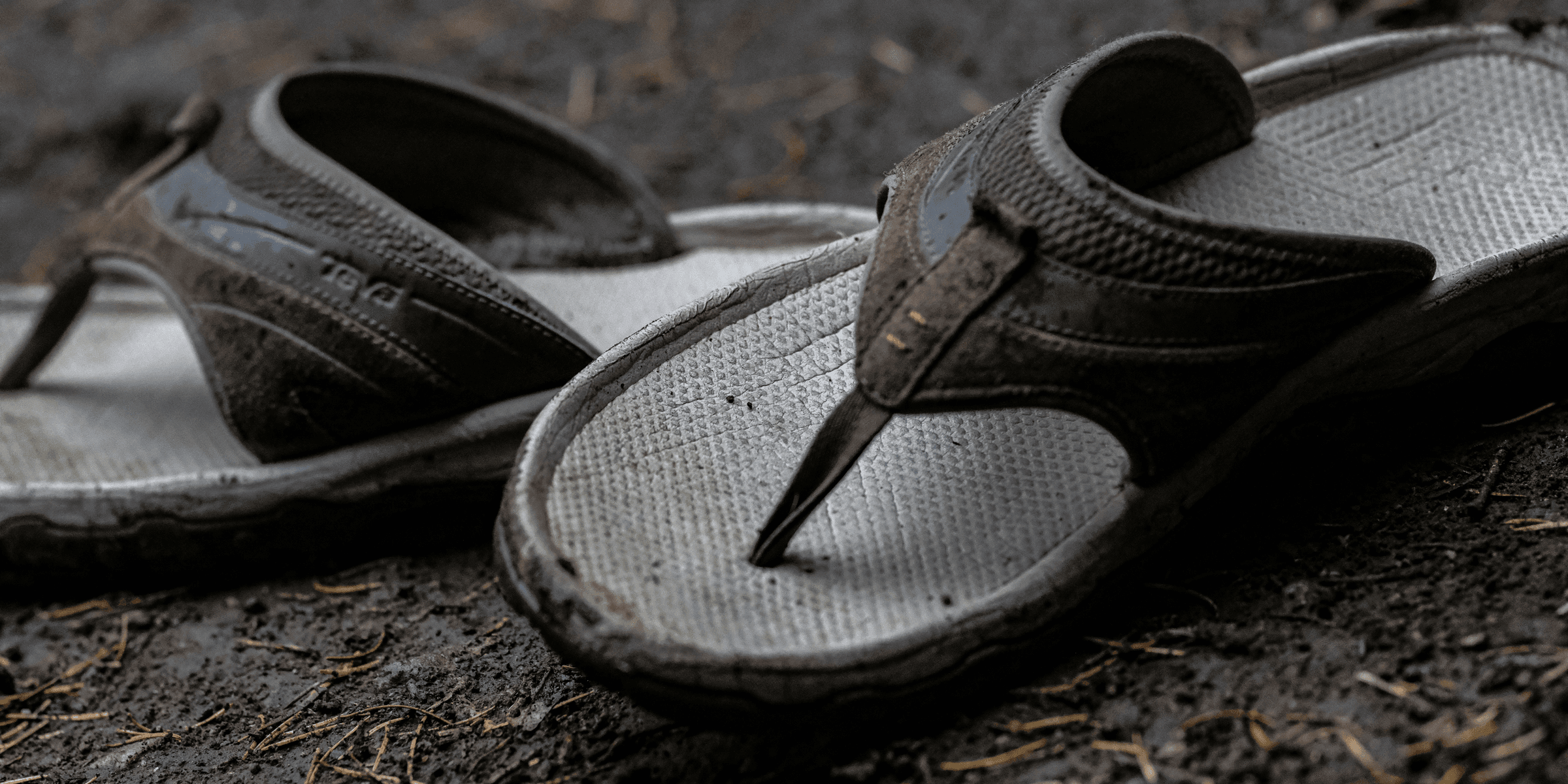 a pair of dirty shoes laying on the ground.