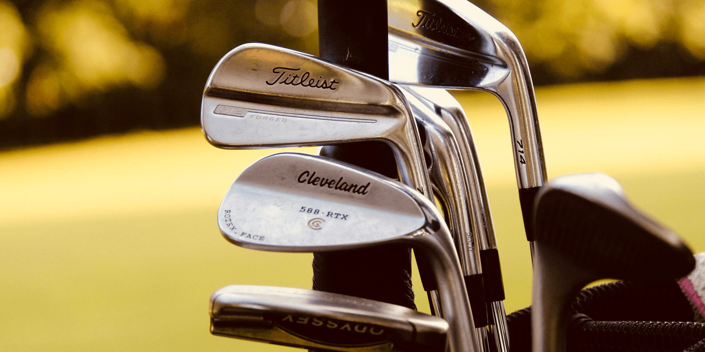gray steel golf clubs on selective focus photo.