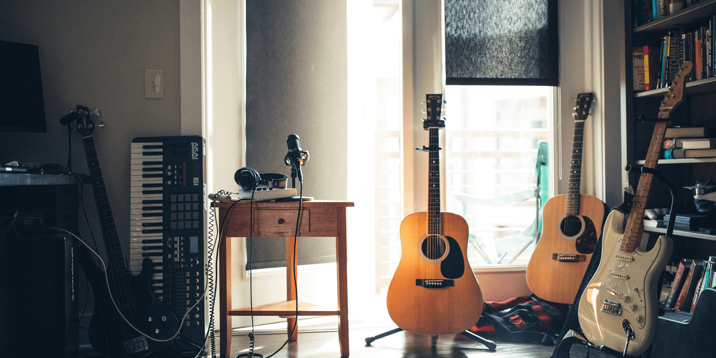 several guitars beside of side table.