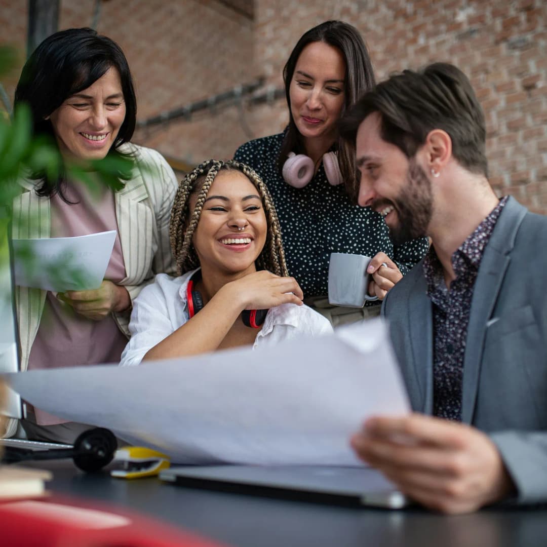 Diverse group of colleagues celebrating success in office