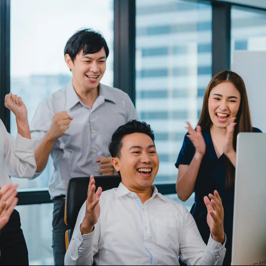 Diverse group of colleagues celebrating success in office